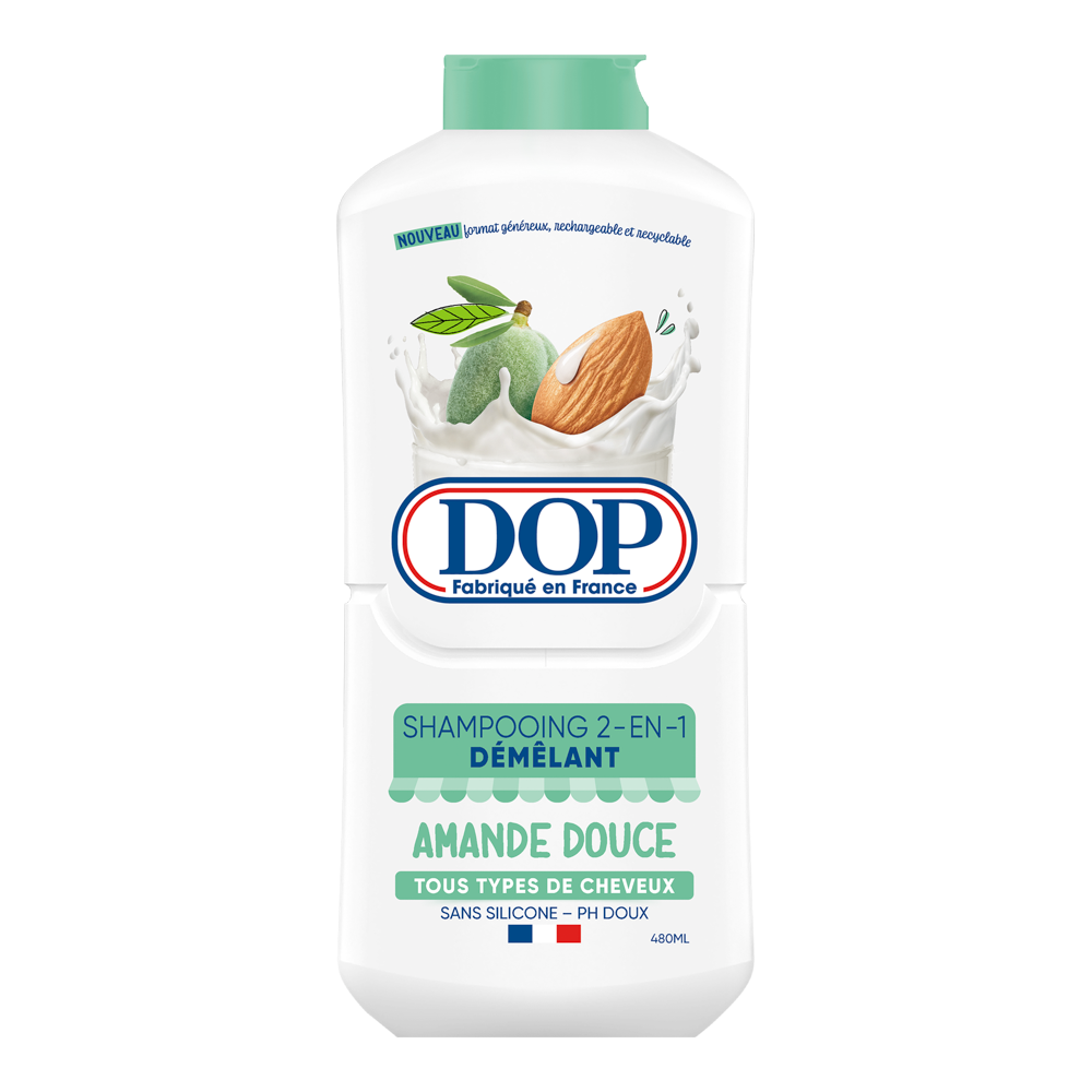 Front view of a white bottle of DOP Shampooing 2-en-1 Démêlant Amande Douce (Sweet Almond 2-in-1 Detangling Shampoo), featuring an image of almonds splashing in milk. The label states it is made in France, suitable for all hair types, silicone-free, pH gentle, and has a 480 ml capacity.