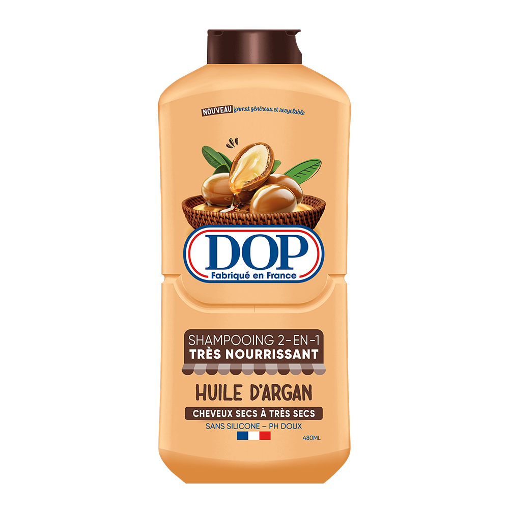 Front view of a brown bottle of DOP 2-in-1 Argan Oil Shampoo (Shampooing 2-en-1 Très Nourrissant Huile d’Argan), featuring an image of argan nuts in a basket. The label states it is made in France, designed for dry to very dry hair, silicone-free, pH gentle, and has a 480 ml capacity.