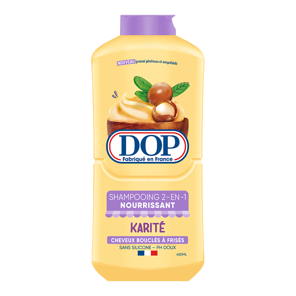 Front view of a yellow bottle of DOP 2-in-1 Nourishing Shampoo with Shea Butter (Shampooing 2-en-1 Nourrissant Karité), featuring an image of shea nuts and creamy shea butter. The label states it is made in France, designed for curly to frizzy hair, silicone-free, pH gentle, and has a 480 ml capacity.