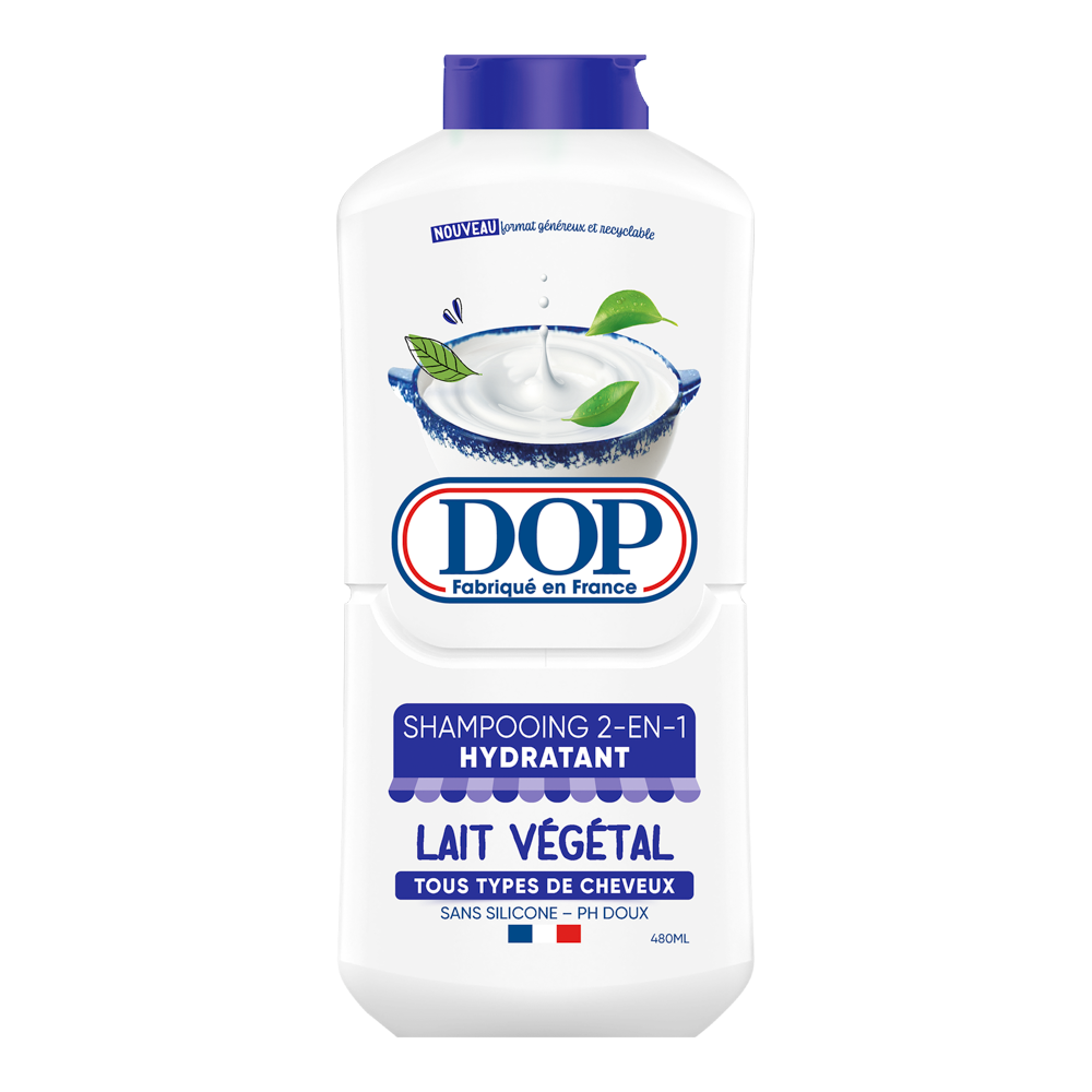 Front view of a white bottle of DOP 2-in-1 Hydrating Shampoo with Plant Milk (Shampooing 2-en-1 Hydratant Lait Végétal), featuring an image of a bowl of creamy plant milk and green leaves. The label states it is made in France, suitable for all hair types, silicone-free, pH gentle, and has a 480 ml capacity.