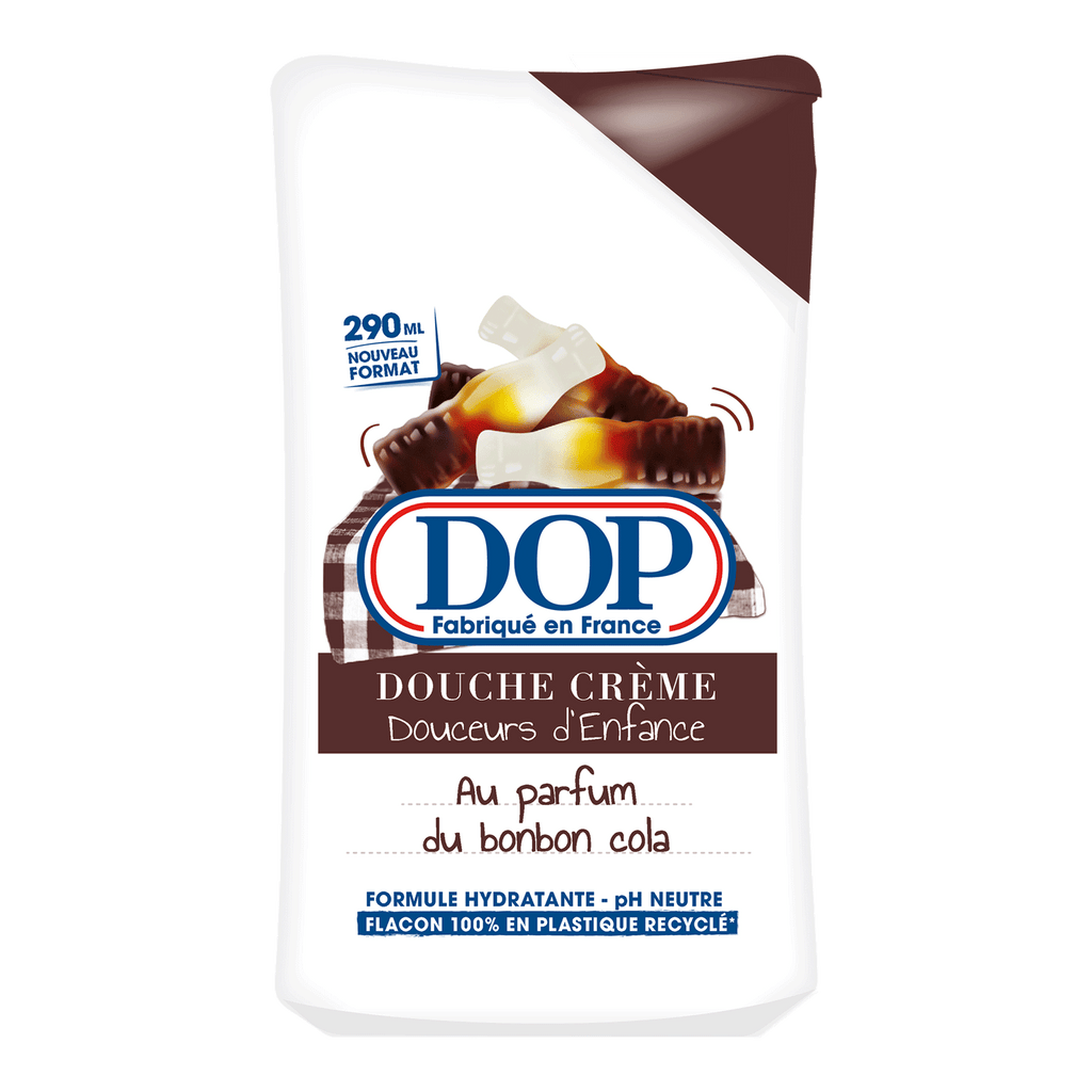 Front view of a white bottle of DOP Douche Crème Douceurs d’Enfance au parfum du Bonbon Cola, featuring an image of cola bottle-shaped gummy sweets. The label highlights a 290 ml format, hydrating formula, pH neutral, and a bottle made from 100% recycled plastic.