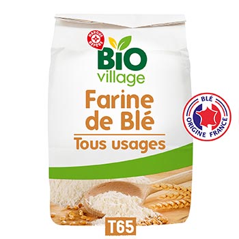 A bag of BIO village Farine de Blé (wheat flour) T65, featuring a white package with green and orange text, a green stripe, and a wheat illustration at the bottom.