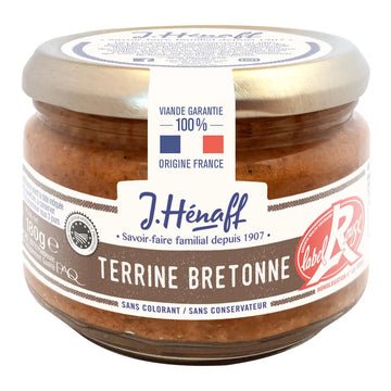 A glass jar of J. Hénaff Terrine Bretonne, featuring a brown pate product inside, a silver metal lid, and a white and brown paper label with French text and a red circular logo.
