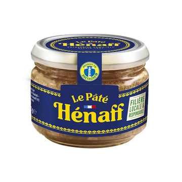 A glass jar of Le Pâté Hénaff Filierne Locale & Responsable, featuring a navy blue label with yellow lettering and a silver metal lid, set against a plain white background.