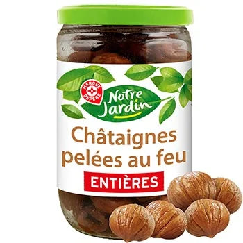 A jar of Notre Jardin whole burnt chateaux (entire dried figs) with a green lid and white label, shown alongside several whole figs on a white background.