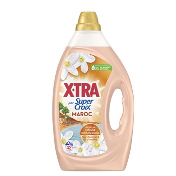 A bottle of Xtra pour Super Croix Maroc fabric softener, featuring a peach-colored liquid inside a translucent bottle with a gold cap and a white floral label.