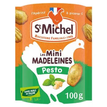 Packaging of Saint Michel Pesto Mini Soft Madeleines 100g, featuring an orange and green design with images of mini madeleines and fresh basil leaves. The front shows a white chicken silhouette with “sans huile de palme” (no palm oil) and the St Michel logo.
