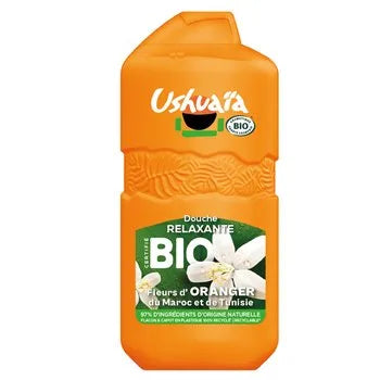 Orange bottle of Ushuaá shower gel with branding and product details on a white background